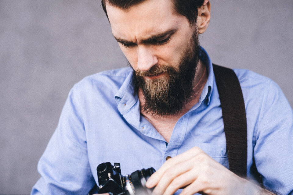 A man holding an analog camera