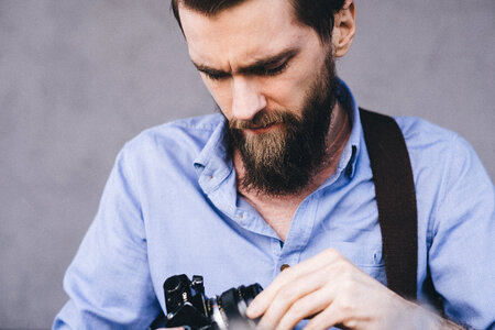 A man holding an analog camera photo