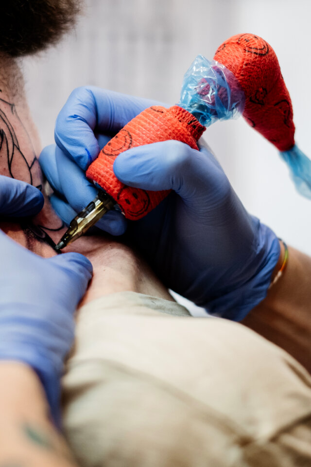 Tattoo artist at work closeup 4
