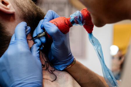 Tattoo artist at work closeup 2 photo