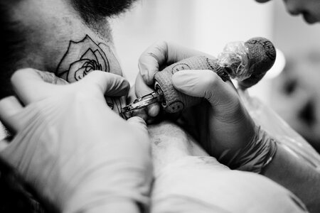 Tattoo artist at work closeup photo