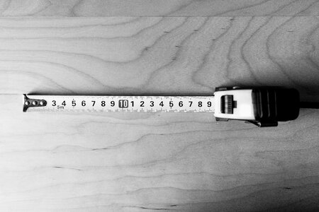 Metal tape measure tool in black and white