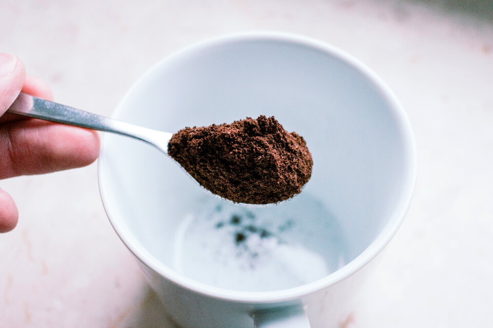 Ground coffee in a spoon