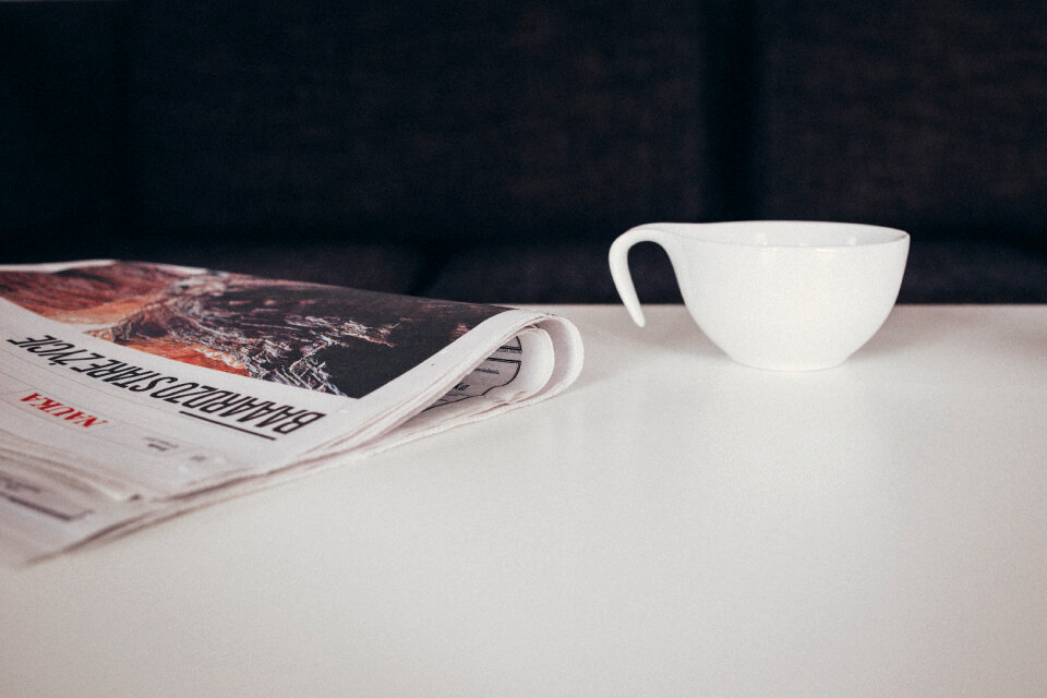 Cup of coffee and a newspaper on the table