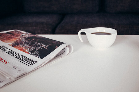 Cup of coffee and a newspaper on the table 2