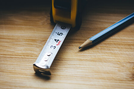 Metal tape measure tool and a pencil photo