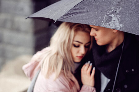 Couple hugging under an umbrella 2