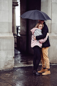 Couple hugging under an umbrella photo