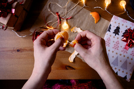A female peeling a mandarin in a festive setting 3 photo
