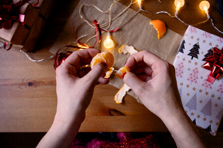 A female peeling a mandarin in a festive setting 3