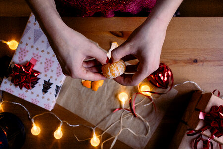 A female peeling a mandarin in a festive setting 2 photo