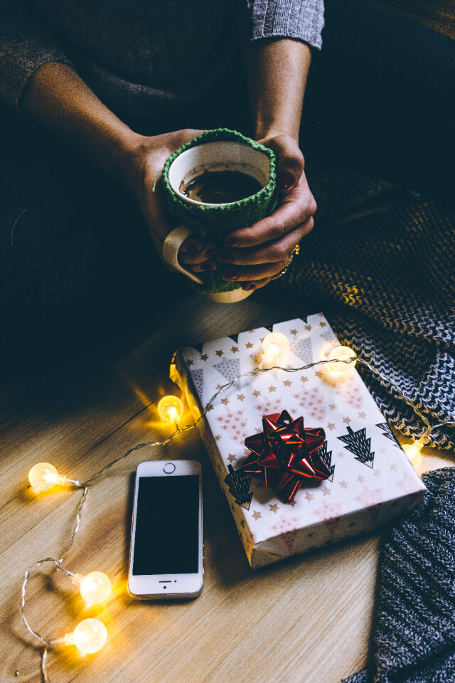 A female holding a mug in a festive setting