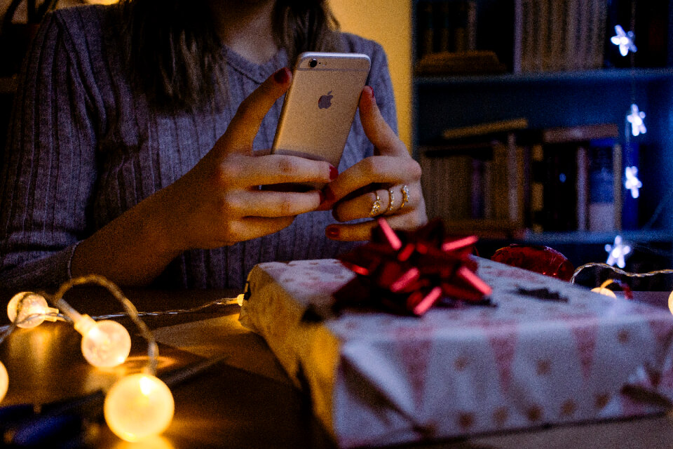 A female taking picture of a christmas gift 4