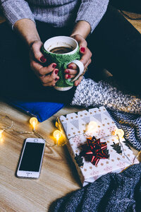 A female holding a mug in a festive setting 2