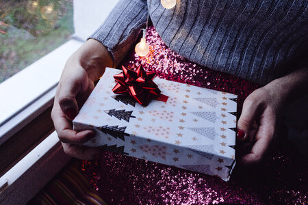 A female holding a christmas gift photo
