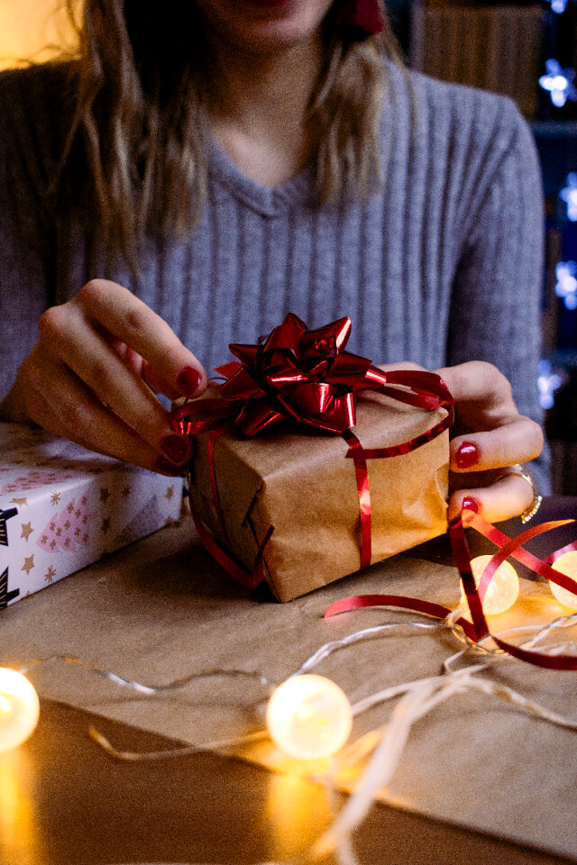 A female decorating a gift 6