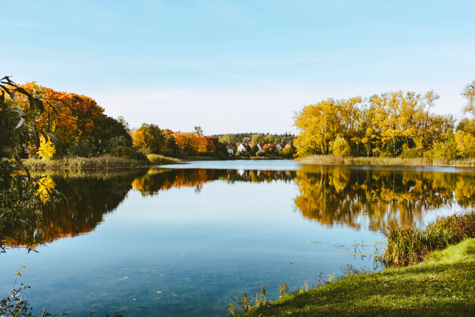 Apartment complex by the lake surrounded by forest
