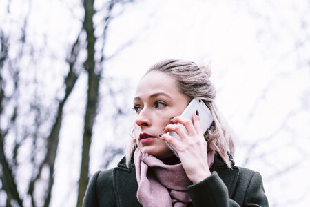 Young woman talking on the phone outdoors photo