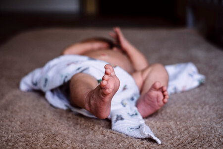 Newborn baby lying down on the mattress photo