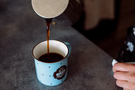 Pouring coffee from a percolator photo