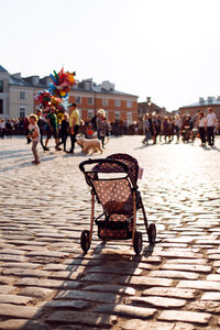 Empty stroller in a crowded Old Town square 2 photo