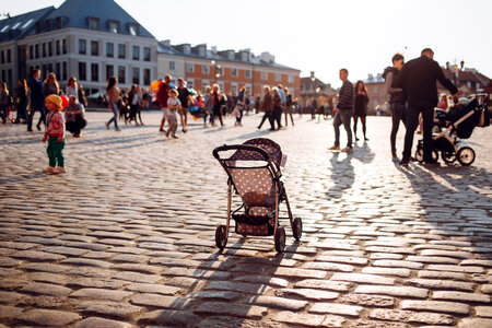 An empty stroller in a crowded Old Town square photo