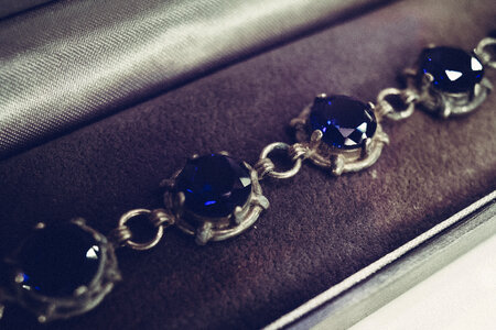 Silver bracelet with blue gems closeup photo