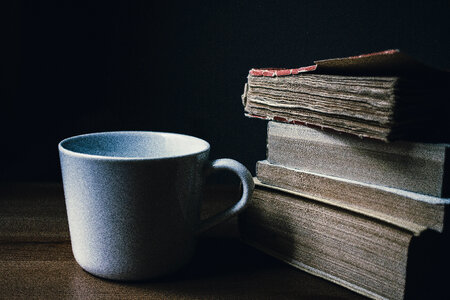 Tea mug and a pile of books photo