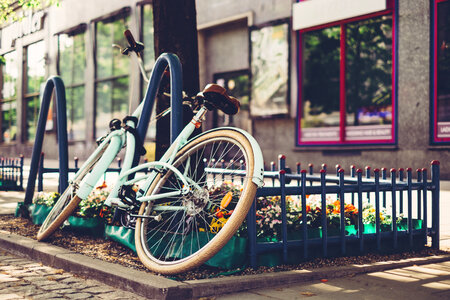 Vintage bicycle leaning against a bike rack 3 photo