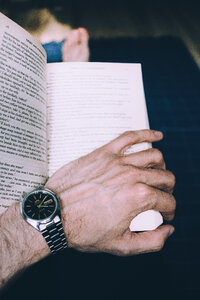 Male hand holding an open book 2 photo