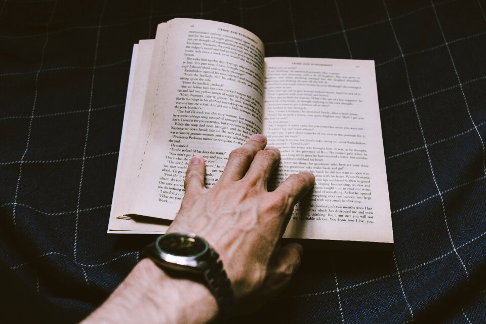 Male hand holding an open book photo