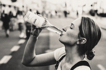 Female drinking soda from a glass bottle photo