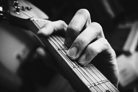 Guitarist hand playing guitar in black and white 2 photo