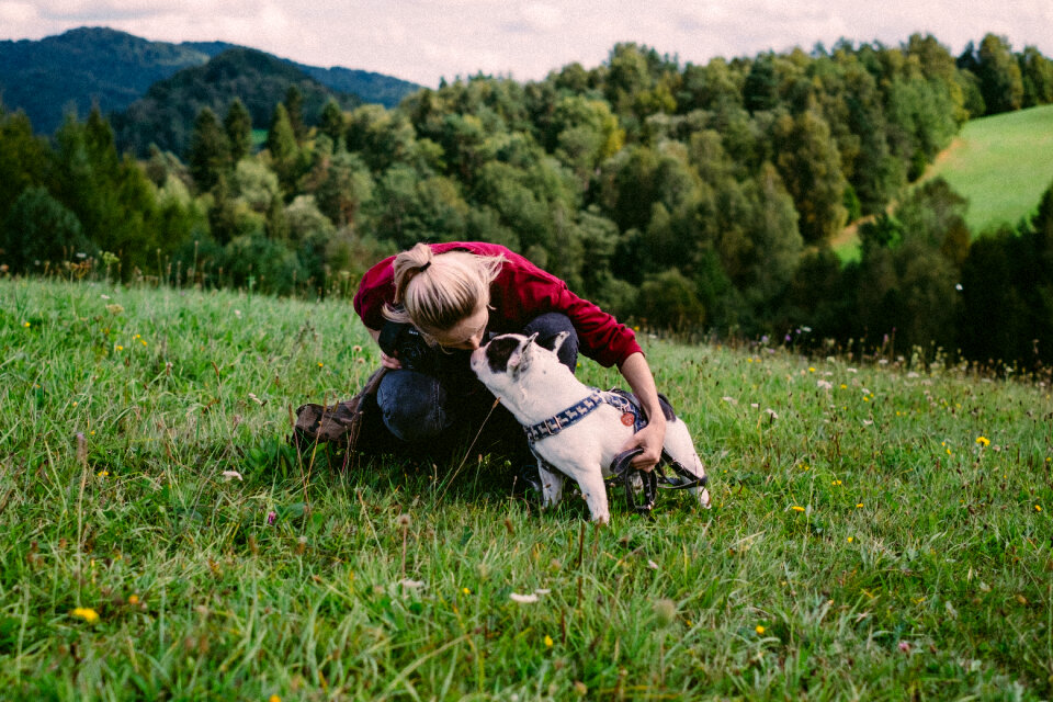 Female tourist with her dog in the mountains