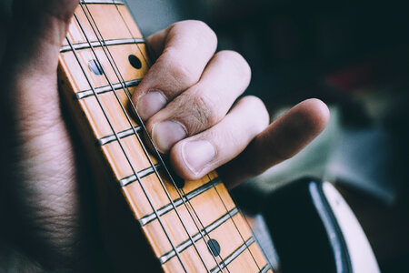 Guitarist hand playing guitar photo