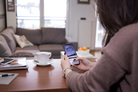 A female holding an iPhone X 2 photo