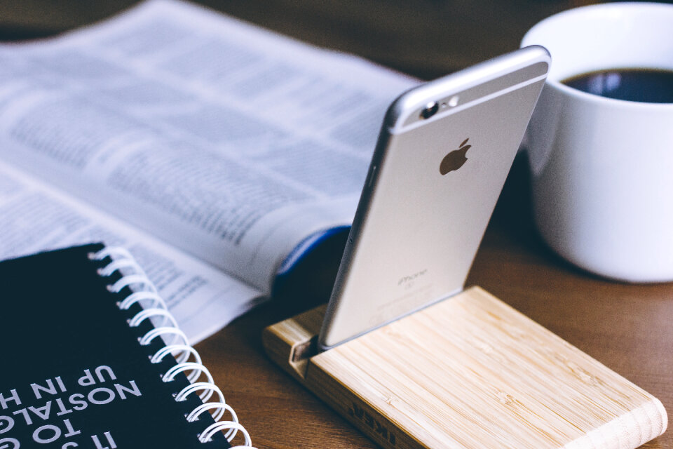 iPhone in a wooden phone holder 2