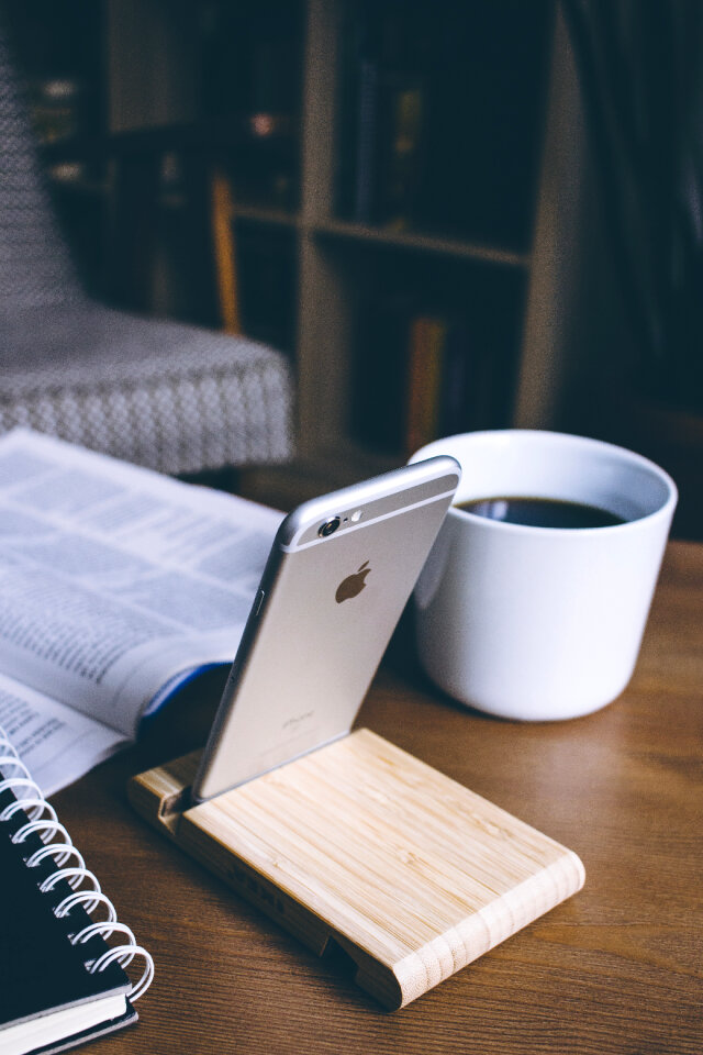 iPhone in a wooden phone holder 3