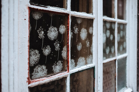 Old wooden window with spray ornaments photo