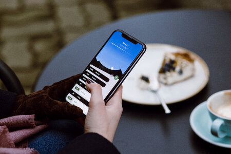 iPhone X in female hands outdoors photo