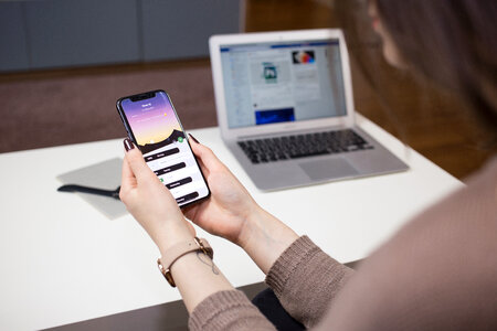 A female holding an iPhone X photo