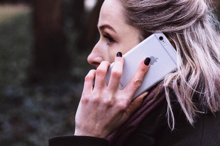 A woman talking on the phone closeup photo