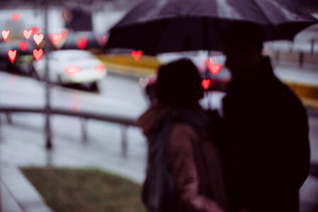Couple silhouettes and traffic lights heart shaped bokeh photo