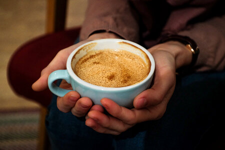 Cup of flat white in female hands photo
