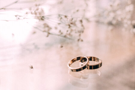 Wedding rings on a glass table photo