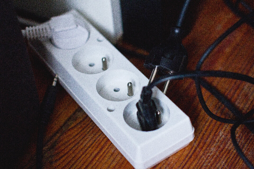 Computer cables plugged into an extension cord