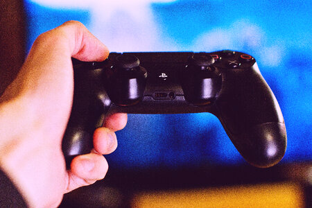 PlayStation pad in a male hand photo