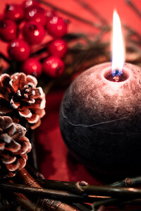 Christmas wreath and a round candle closeup photo