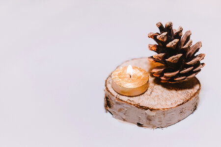 Gold tealight and a pinecone photo