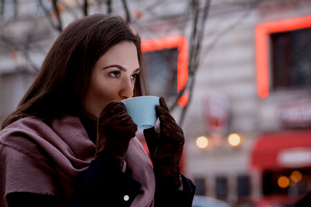A woman drinking coffee outdoors 2 photo